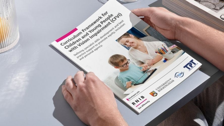 Hands holding a copy of the CFVI Framework